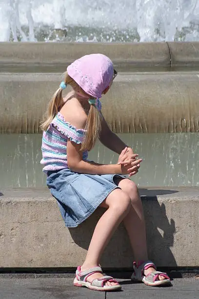 girl sitting beside the water