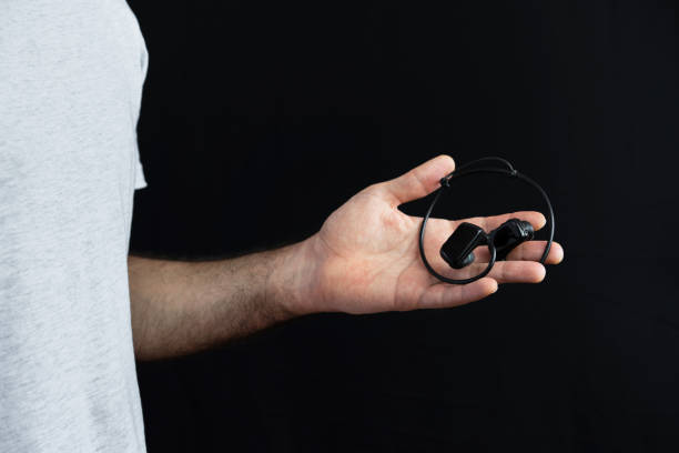 istock Man holding wireless headphones in his hand 1441903206