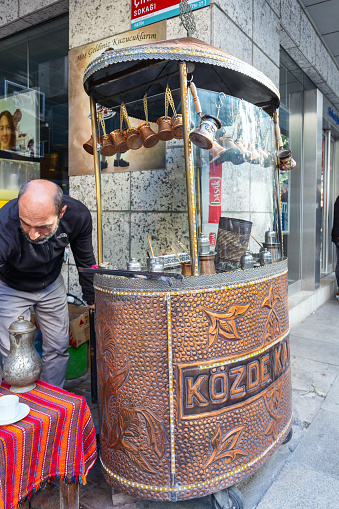 Istanbul, Turkey - May 19, 2022: A man is cooking Turkish coffee in a traditional way in the center of Istanbul. It says \