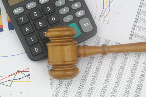 istock Arbitration concept, wooden judge gavel and calculator on financial documents. 1441904065