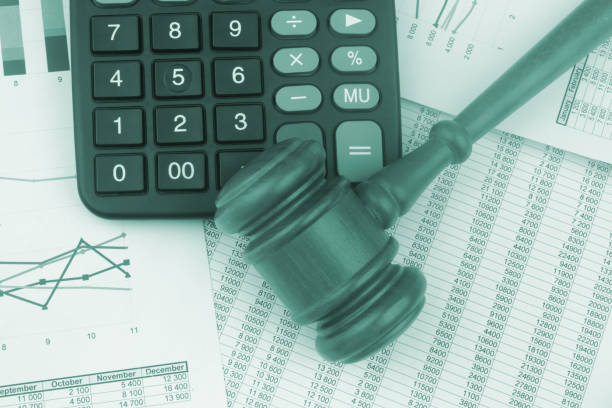 istock Arbitration concept, wooden judge gavel and calculator on financial documents. 1441904067
