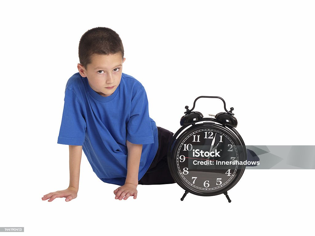 Alarm clock Child sat next to a big alarm clock Alarm Clock Stock Photo