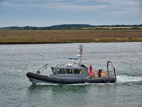 The Fisheries Protection Vessel (FPV) Sebastian Terelinck leaves Cromer on an overcast afternoon. A boat of the Eastern IFCA (Inshore Fisheries and Conservation Authority).