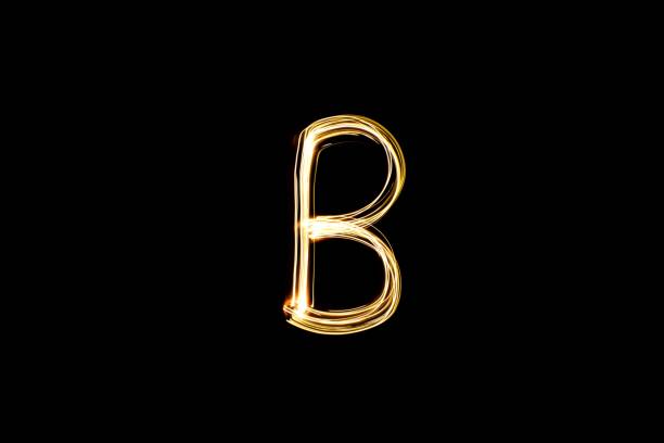 istock Light painting yellow letter B on black background 1441906547