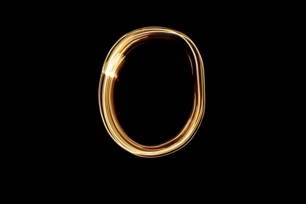 istock Light painting yellow letter O on black background 1441907935