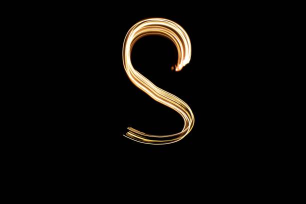 istock Light painting yellow letter S on black background 1441908002