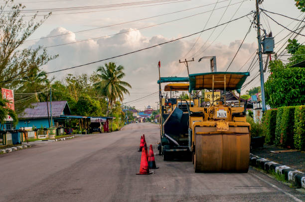 a road roller parked on the roadside