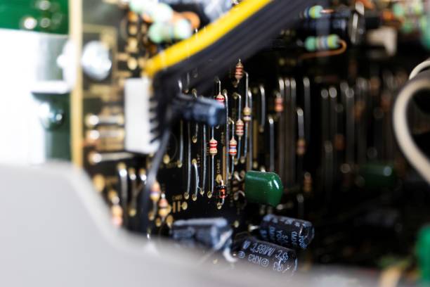 istock A portrait focused on a bunch of resistors on a black electronics print or circuit board in an open device in between other soldered components like capacitors. 1441908621