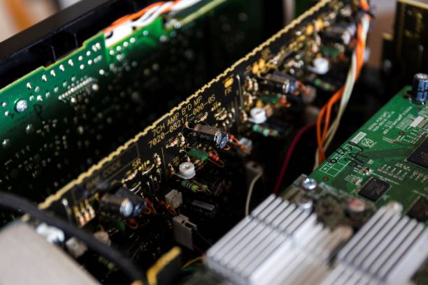 istock some green and black circuit boards in an open electronic device with electric components soldered on them, like resistors, capacitors and inductors wconnected by solder tracks. 1441908688