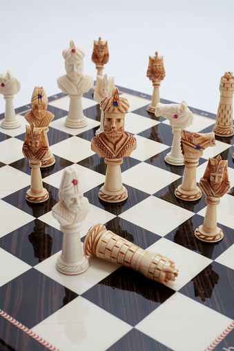 Chessboard with placed pieces on a white background, isolated image