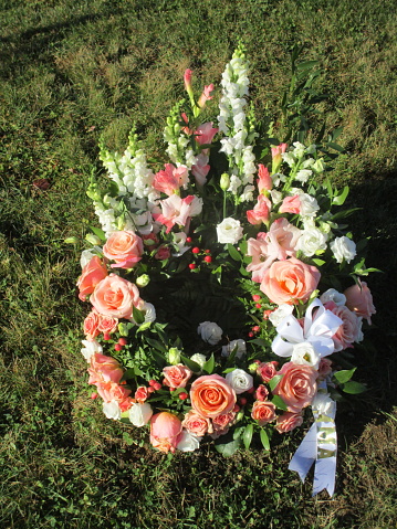 a funeral wreath laid on the ground in a cemetery