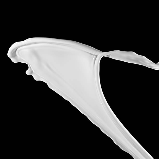 istock Milk splash, isolated on black background. white splash 1441913270