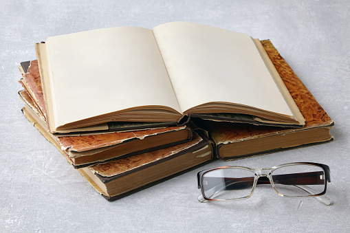 Office: Book and Reading Glasses Isolated on White Background