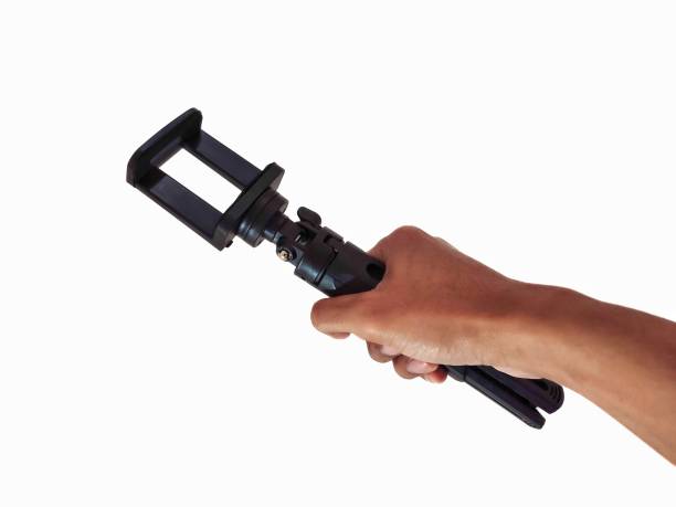 istock Hand holding a mini tripod isolated on white background 1441914886
