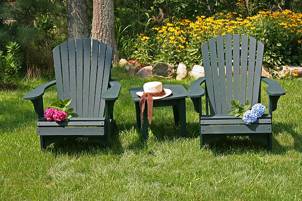 two lawn chairs in a garden stock photo