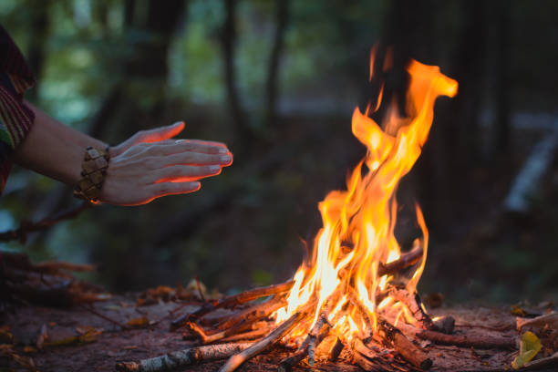 istock Close up hands warming over campfire concept photo 1441915120