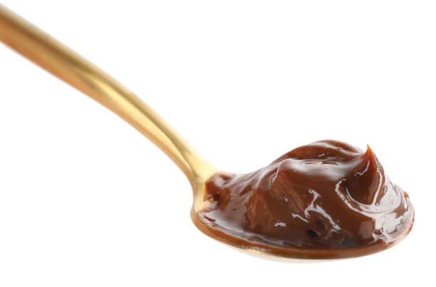 istock Spoon with tasty boiled condensed milk isolated on white 1441917521