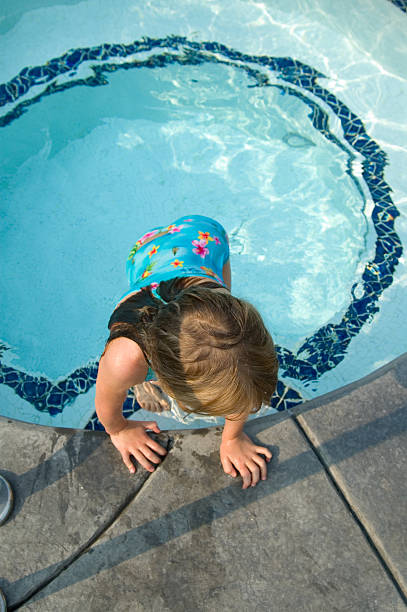 istock Young girl emerging from round pool 144191782