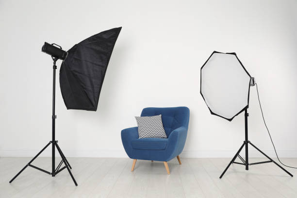 istock Comfortable armchair and professional lighting equipment in photo studio 1441918927