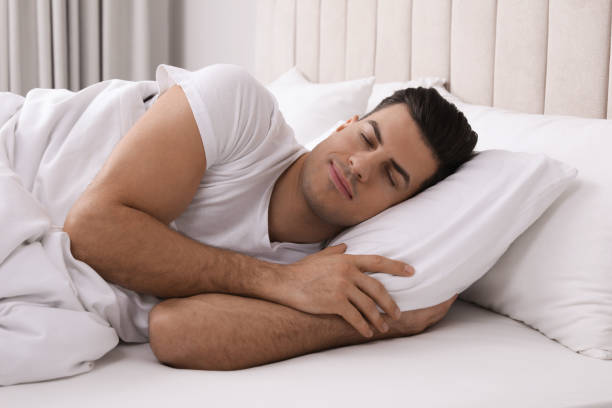 istock Handsome man sleeping in bed at home 1441919019