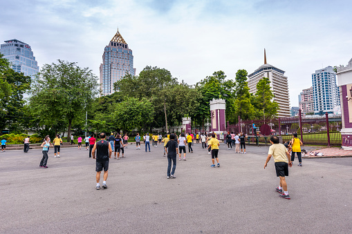 Bangkok, Thailand - July 2, 2012: people practicing Tai Chi in Lumphini Park early in the morning. Tai Chi is a Chinese martial art characterized by slow movements.