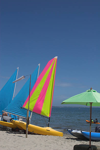 Beach scene with yachts and canoe stock photo