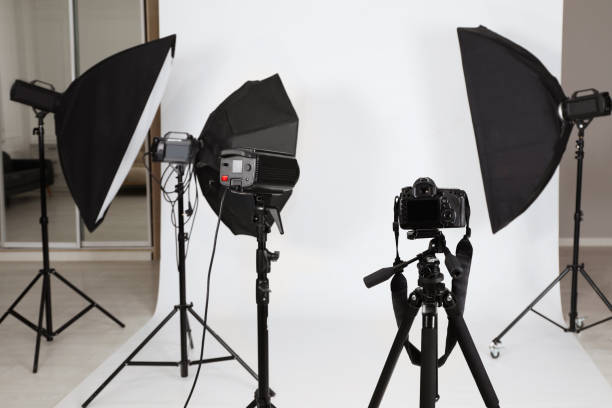 istock Tripod with camera and professional lighting equipment in photo studio 1441920450