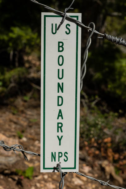 istock US Boundary SIgn Hangs on Barbed Wire Fence 1441920755