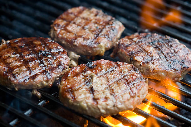 Hamburgers on the grill Come and get it! grill burgers stock pictures, royalty-free photos & images