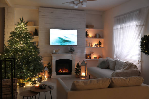 istock Stylish living room interior with TV set, Christmas tree and fireplace 1441922442