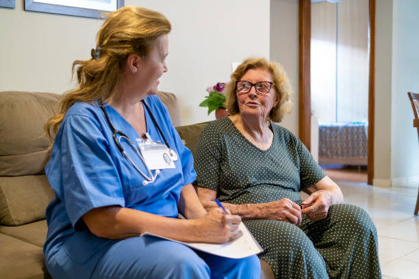 istock Nurse visiting a senior woman at home. 1441922457