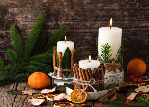 istock Burning Christmas or advent candles decorated with natural material. 1441922831