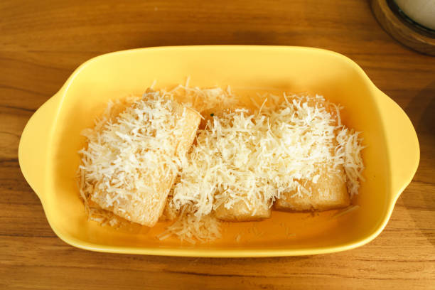 istock Singkong keju or fried cassava (Manihot esculenta) served with cheese topping put on yellow table 1441923072