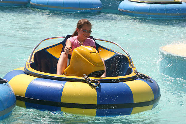 Bumper boats ride at waterpark  Young girl having fun in bumper boats bumper stock pictures, royalty-free photos & images