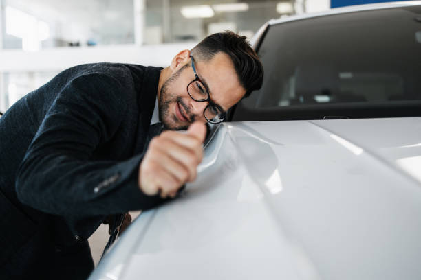 istock Car salesman checking new car 1441924147