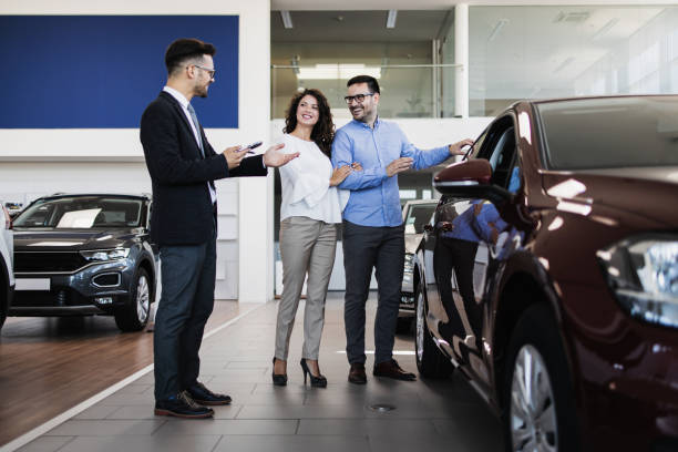 istock Attractive couple buying new car 1441924165