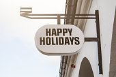 Happy Holidays. Shop light sign. Building facade