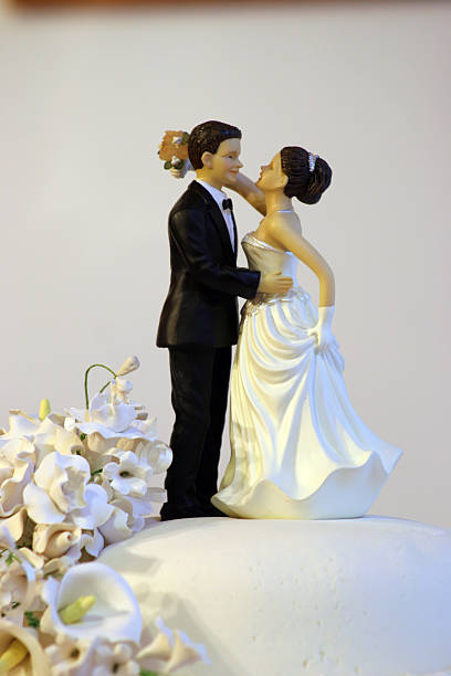 istock Bride and Groom on Wedding Cake 144192674