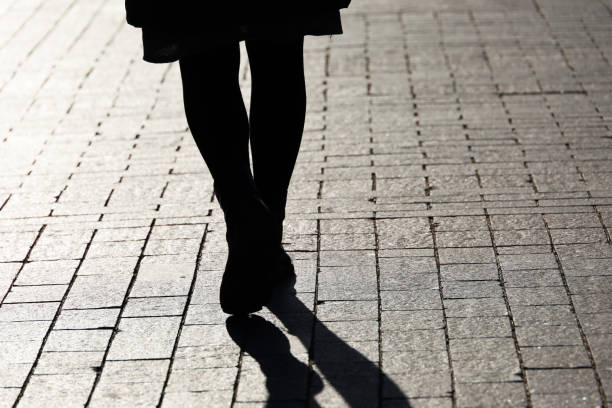 istock Female legs in boots on a street 1441928990