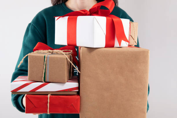 istock Woman is Holding Christmas Present in Her Hands 1441930673