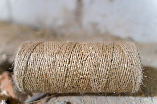 A skein of jute thread close-up lies on the floor