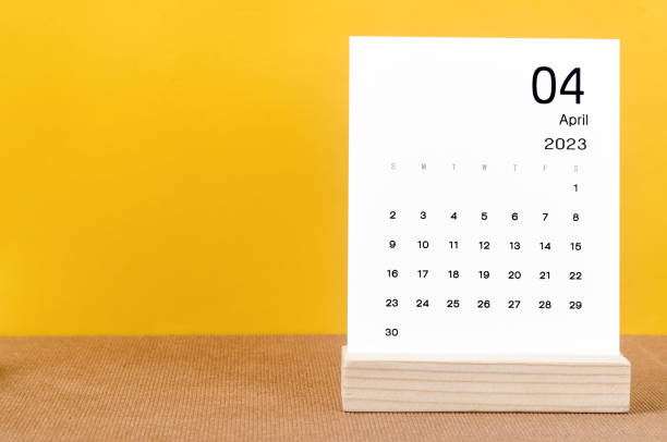 The April 2023 Monthly calendar for 2023 year on yellow table. stock photo