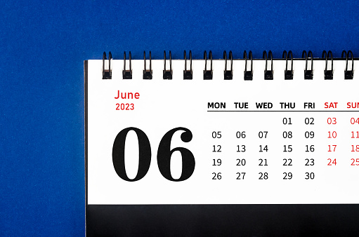 June 2023 Monthly desk calendar for 2023 year on blue background.