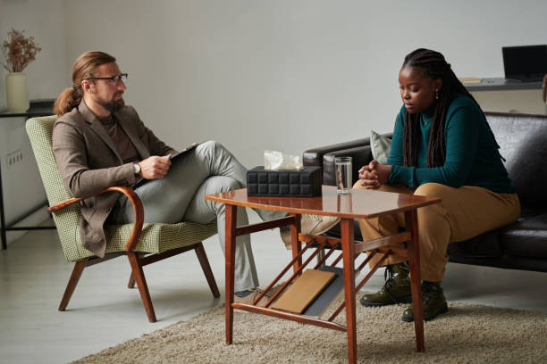istock Psychologist talking to patient at office 1441932618