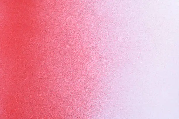 Photo of gradient red spray paint on a white paper background