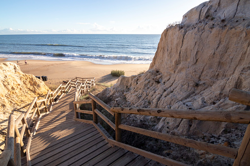 One of the most beautiful beaches in Spain, called (Cuesta Maneli, Huelva) in Spain.  Surrounded by dunes, vegetation and cliffs.  A gorgeous beach.
