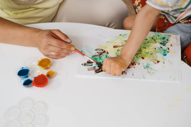 istock Child with cerebral palsy painting, mental physical problem, sensory therapy 1441939853