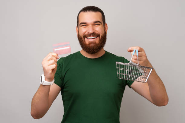 Pay all your purchases with credit card says a man holding a shopping basket. stock photo