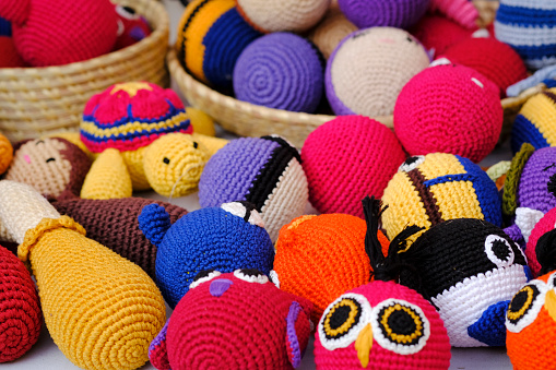 Colorful handmade knitted dolls showcase at the fair in Pune, India.