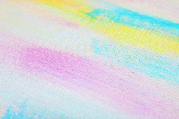 Strokes of different pastel acrylic paints on white canvas, closeup